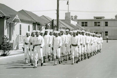 Black & White image of recruits marching through the Manhattan Beach Training Station in Brooklyn, New York.