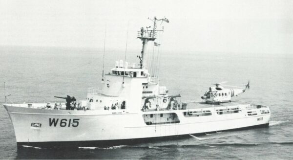 Profile photo of Coast Guard cutter Reliance with helicopter.