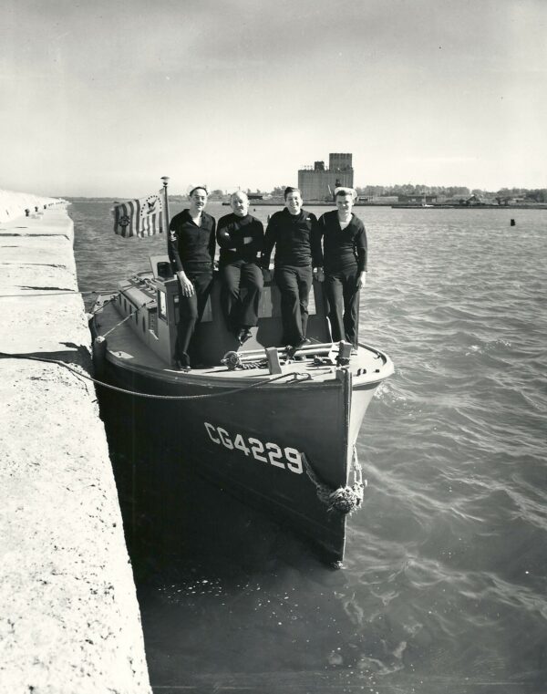 Photo: Crew poses on deck of docked picket boat.