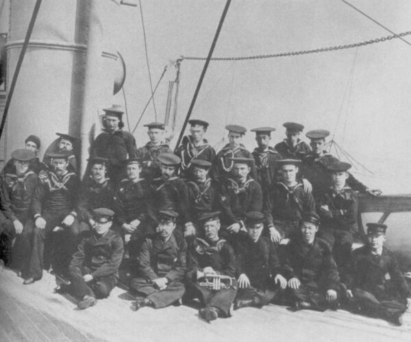 Early photograph of crewmembers of the Bering Sea Patrol cutter Bear with Asian national crew members seated in the bottom row.