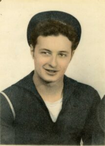 Colorized black and white photo of Seaman John “Jack” DeNunzio in dress blues
