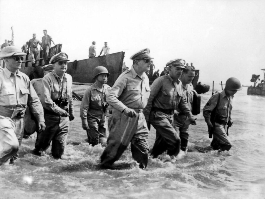 Photo: General Douglas Macarthur disembarks on the beaches of Leyte Island, seen walking with his staff.