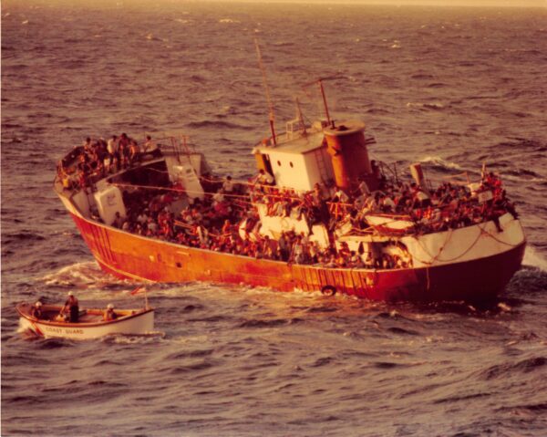 Photo: A Coast Guard motor lifeboat approaches an old coastal freighter overloaded with Cuban refugees.