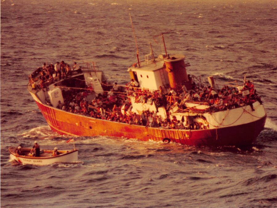 Photo: A Coast Guard motor lifeboat approaches an old coastal freighter overloaded with Cuban refugees.