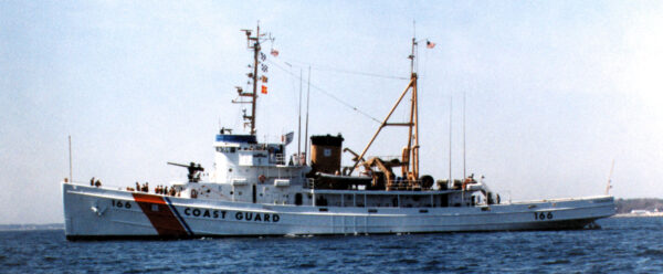 Photo: Color photograph of the Coast Guard cutter Tamaroa (hull number 166) underway in calm seas, port side view, with “COAST GUARD” painted on the hull.