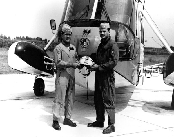 Photo: Mixon and Rittichier pose in front of their helicopter.