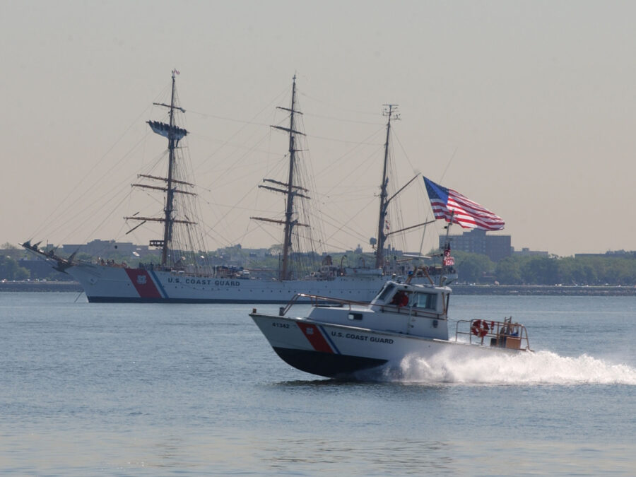 Photo: A Coast Guard rescue boat races past the Coast Guard Cutter Eagle