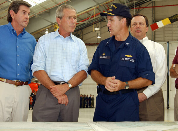 Photo: President Bush receives a briefing from Coast Guard Capt. Dave Callahan