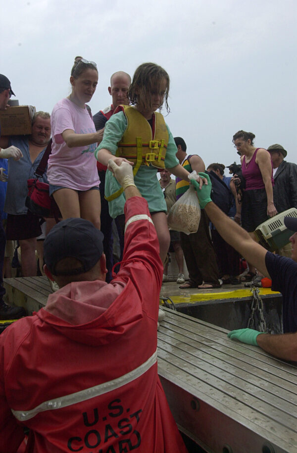 Photo: Coast Guard personnel help New Orleans residents off a barge