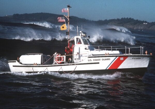 Photo: A starboard profile view of a 44-foot motor lifeboat navigating in heavy seas