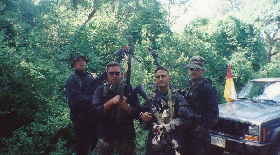 Photo: Rodriguez with fellow Coast Guard DIAT team members in camo gear.