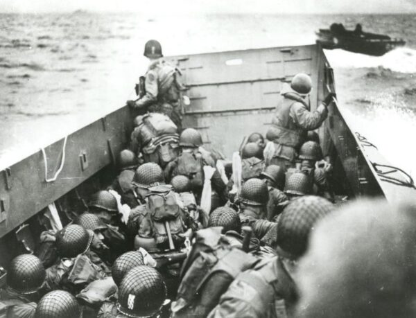 Photo: U.S. Army troops crouch behind the bulwarks of a landing craft as it nears Omaha Beach on D-Day.