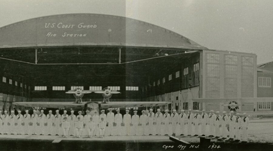 A 1934 panoramic photograph of Coast Guard Air Station Cape May with hangars, personnel, and aircraft.