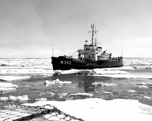 B&W photo: Coast Guard Cutter Bramble (WLB-392) surrounded by ice transit the famous and historic Northwest Passage in 1957.