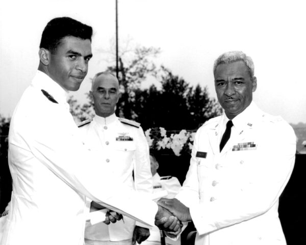Black and white photo of officers shaking hands at the Coast Guard Academy.