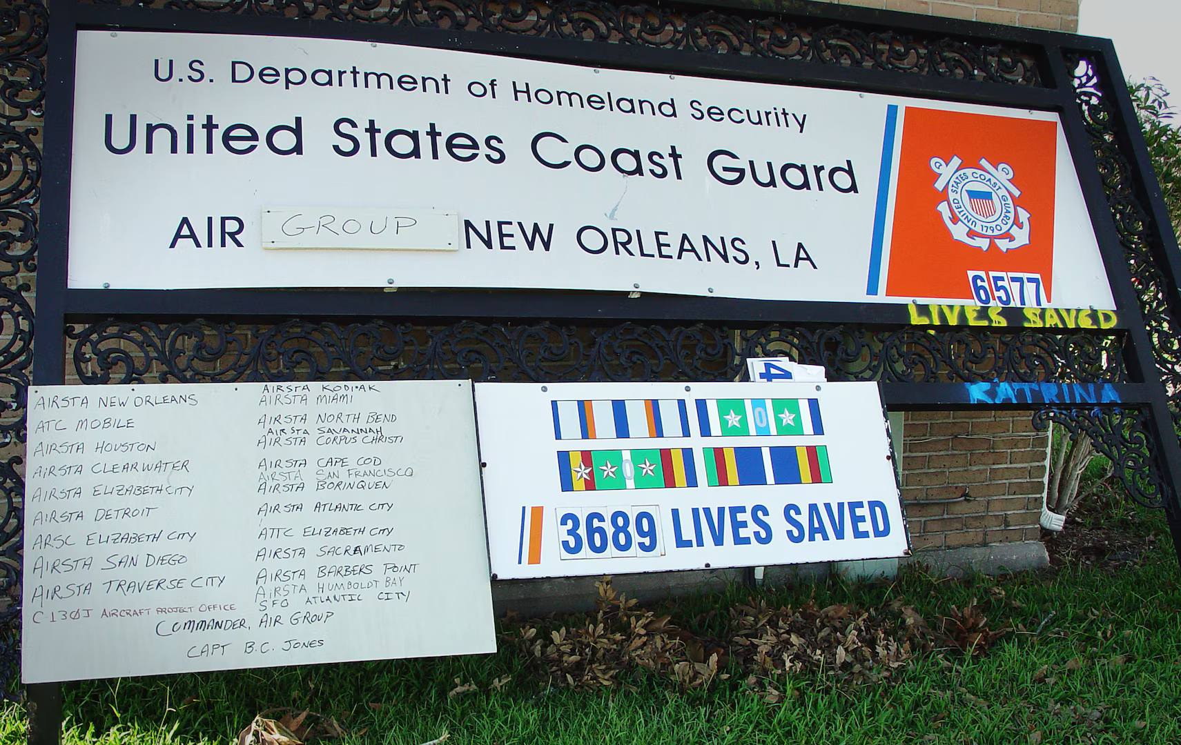 Photo: U.S. Coast Guard Air Station New Orleans sign leaning against a building after hurricane Katrina made landfall in August 2005.