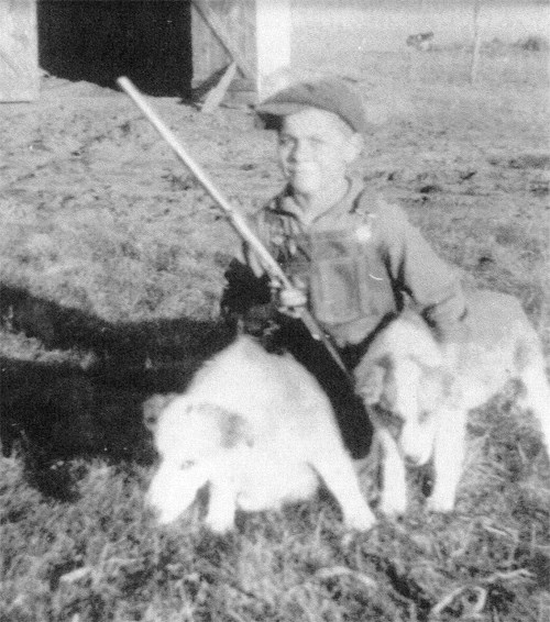 Photo: Young Rollin Fritch poses with his dogs.