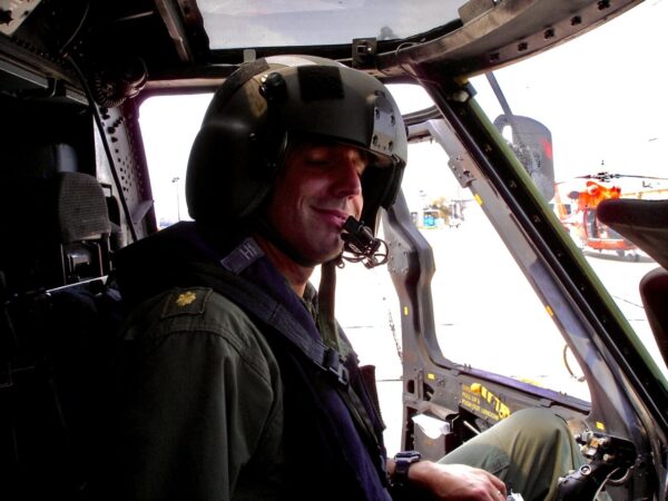 Media Item 1. Insert media item Photo: Lt. Cmdr. Jim O’Keefe at the controls of a Coast Guard HH-60J helicopter.