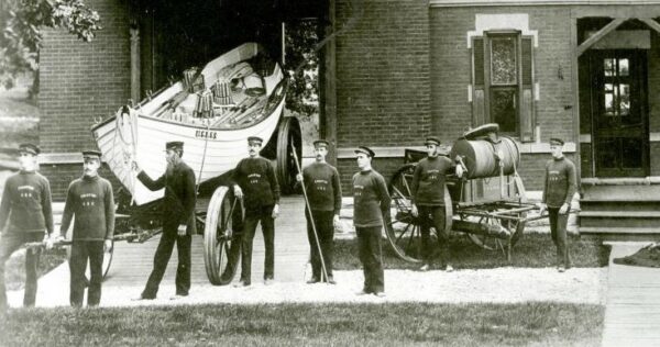 Keeper Lawson and surfmen standing by the station’s Beebe type pulling surfboat on its boat wagon.