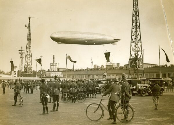 Photo: Graf Zeppelin hovering over a crowd of onlookers in Berlin, Germany.
