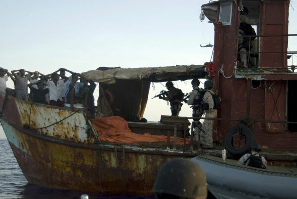 Photo: Armed LEDET team members detain suspects while boarding a ship.