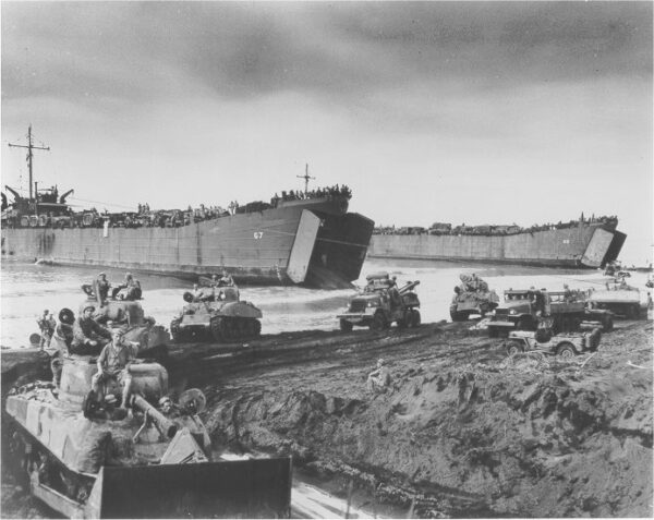 Photo: Tanks being unloaded from LSTs and driving ashore.