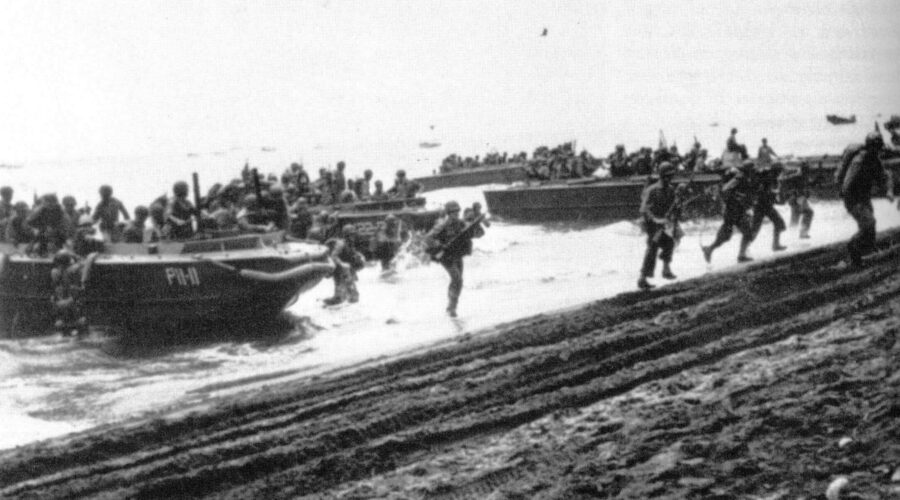 Photo: Marines landing at Guadalcanal rush on shore.