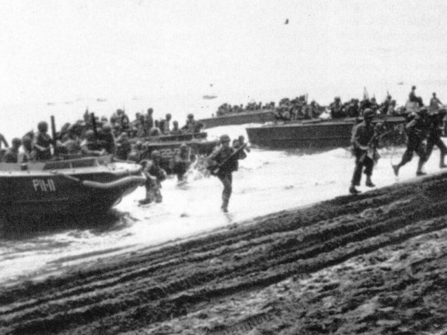 Photo: Marines landing at Guadalcanal rush on shore.