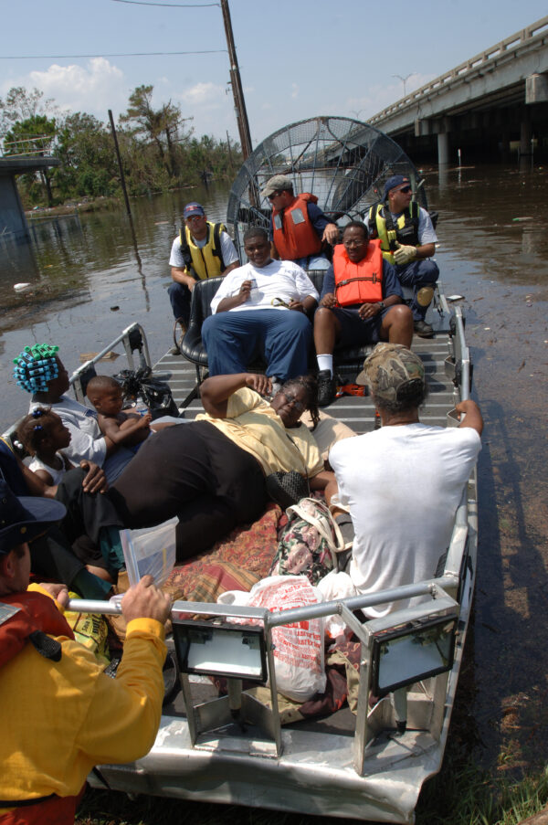 Photo: Boatload of evacuees navigates through flooded area.