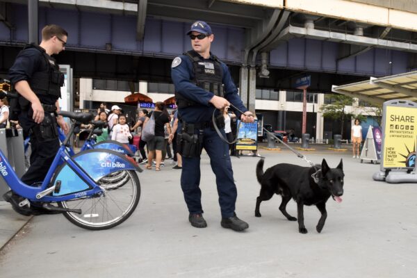Photo: Coast Guard security with canine conduct security sweep near a bikeshare station.