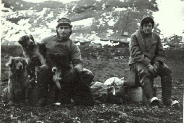 Photo: Radioman 2nd Class Jeano Campanaro with a fellow service member and the radio station’s dogs.