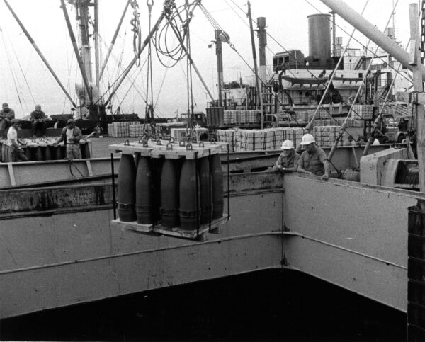 Photo: Artillery rounds are offloaded from a ship.