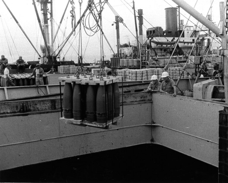 Photo: Artillery rounds are offloaded from a ship.