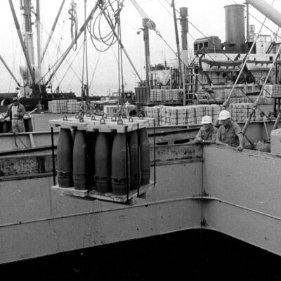 Photo: Artillery rounds are offloaded from a ship.