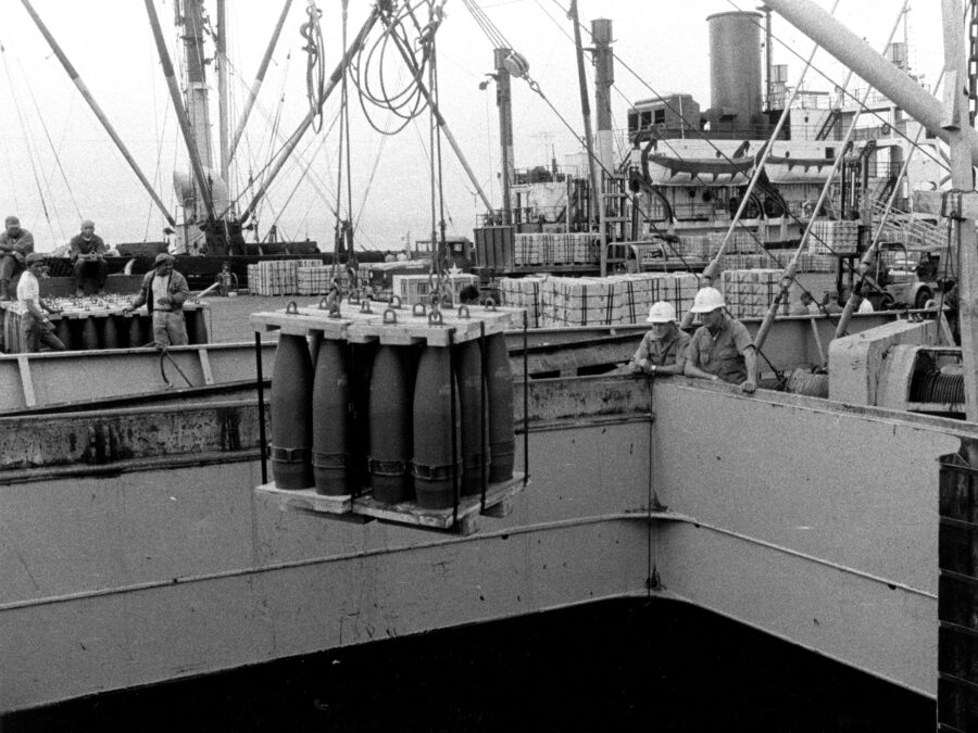 Photo: Artillery rounds are offloaded from a ship.