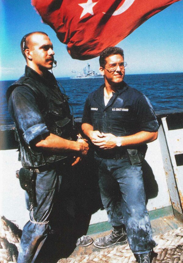 Photo: Two Coast Guardsmen pose at the bow of a Turkish freighter.