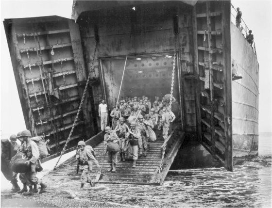 Photo showing LST-66’s bow doors open to debark troops to the beach.