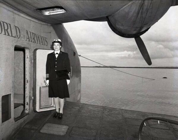 Photo: CAPT Dorothy Stratton standing on wing of Pan American Clipper seaplane.