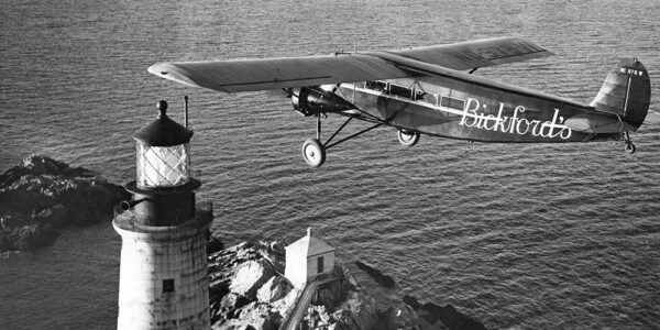 Photo: A Ford Tri-Motor plane with lighthouse below.