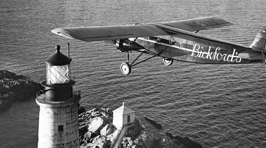 Photo: A Ford Tri-Motor plane with lighthouse below.