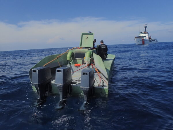 Photo: “Steadfast” boarding team take control of low-profile vessel (LPV). Rear view highlights 3 powerful outboard motors.