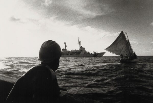 A Coast Guardsman from the Chase prepares to board the 35-foot sailing vessel Exoribe.