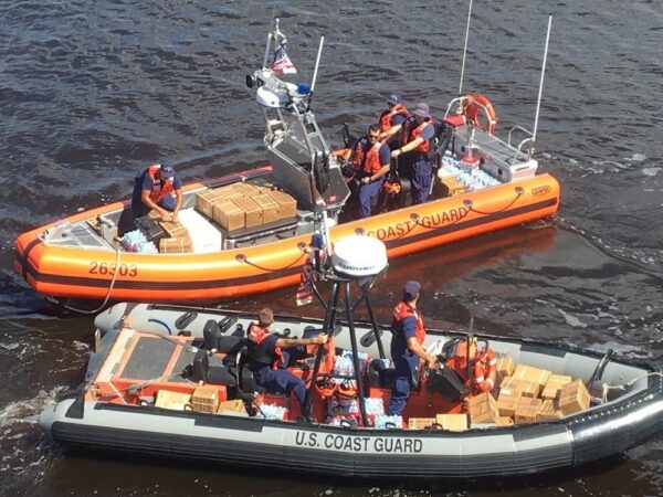 Photo: Two Coast Guard boats side-by-side loaded with supplies.