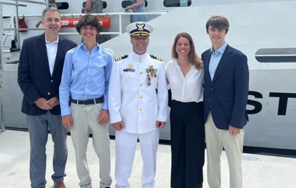 Photo: Cmdr. Tyler Kelley celebrates the completion of his successful tour with Meredith Dignan and her family.