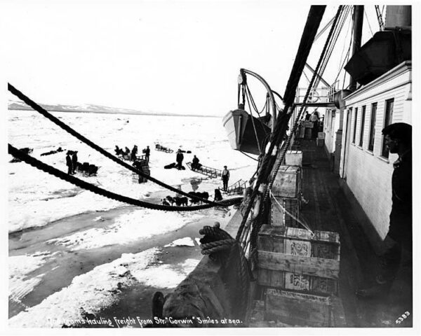 Photo: A view from the side of the ship over the ice where supplies are being offloaded onto the ice.