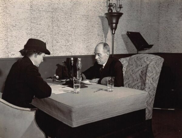 Photo of Dorothy Stratton seated at table with VADM Russell R. Waesche.