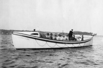 Photo: Port view of a Type “E” motor surfboat with crew.