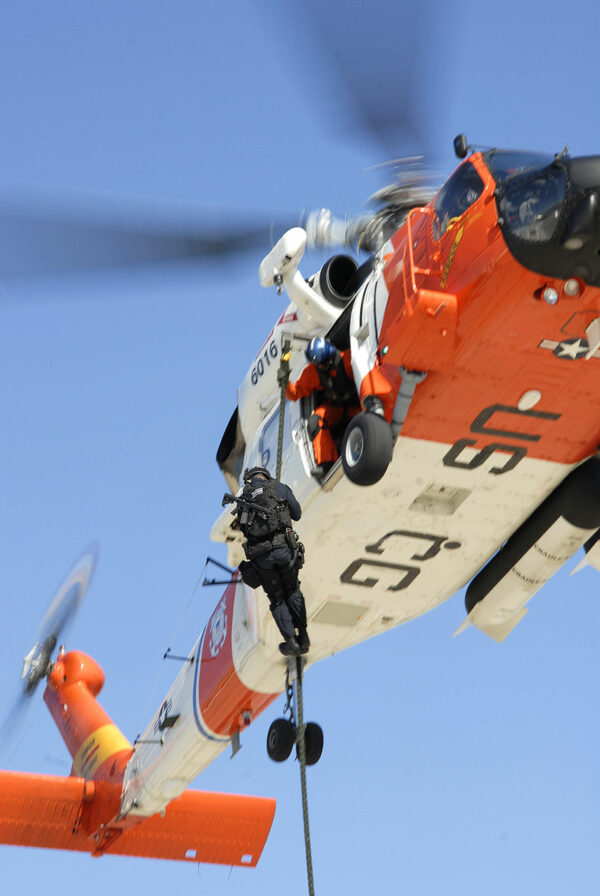 Photo: A LEDET team member goes down a rope from a helicopter.