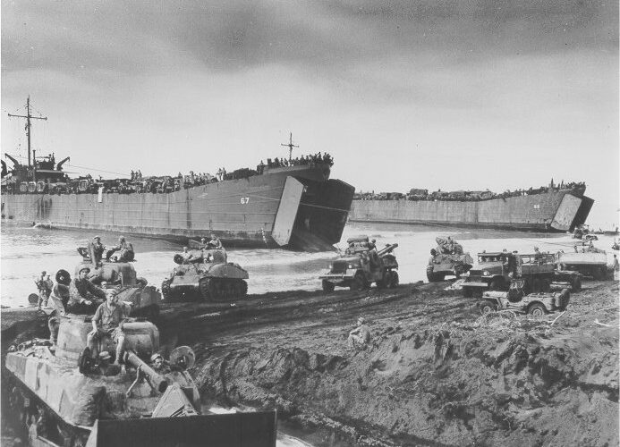 Photo: Two LST's unload tanks.