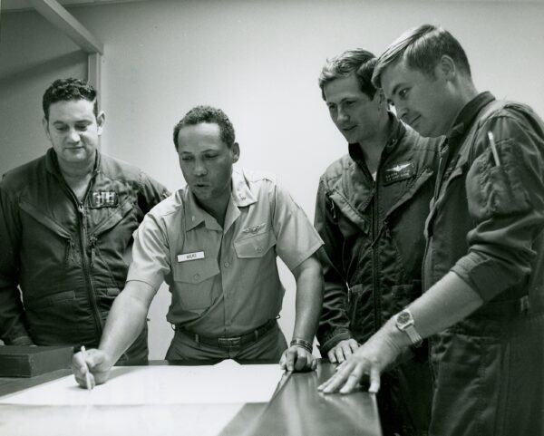 Photo: CDR Wilks in meeting with a group of aviators.